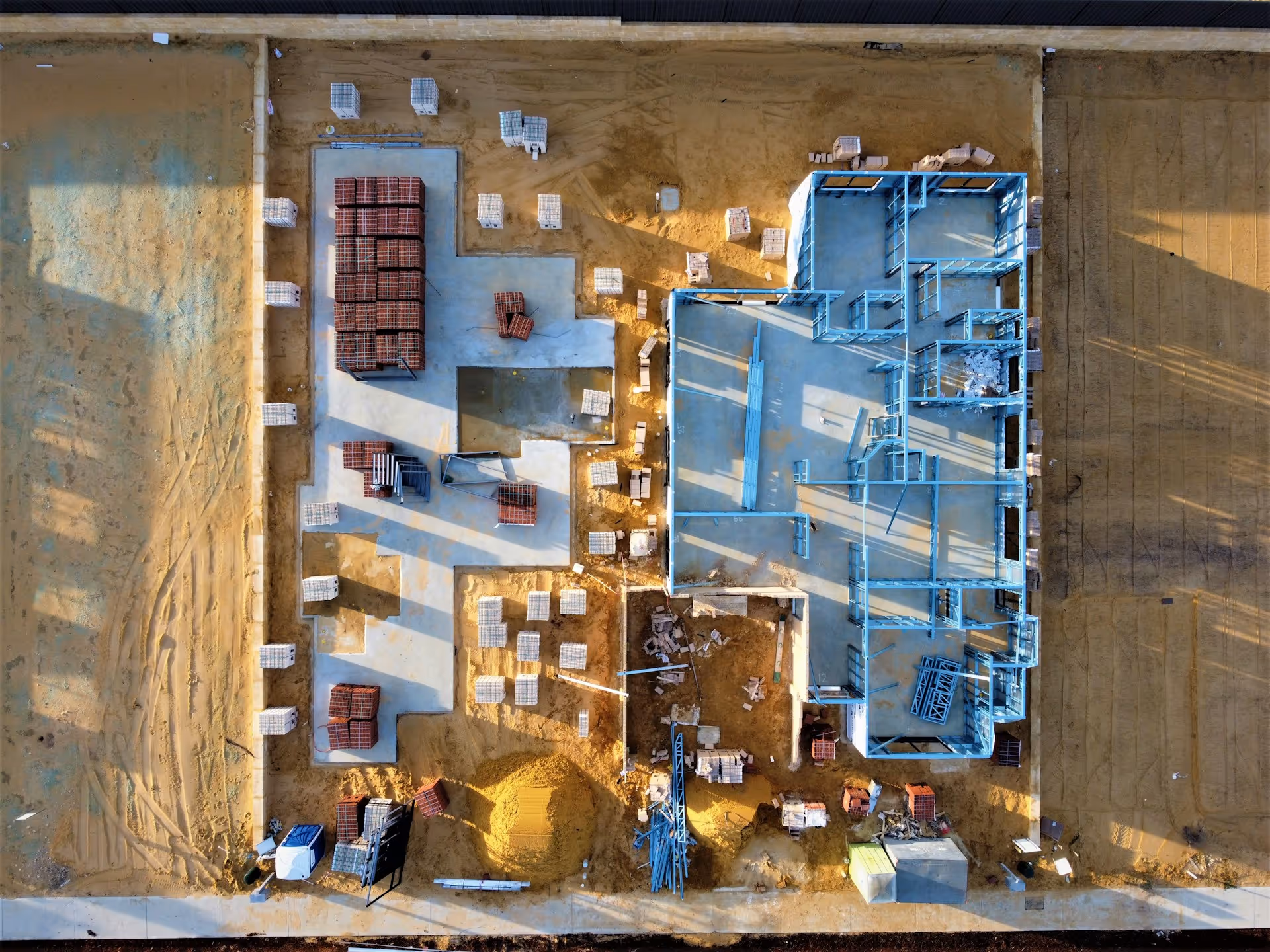 Aerial drone view of a new home under construction showing steel frame and foundations in Perth, Western Australia