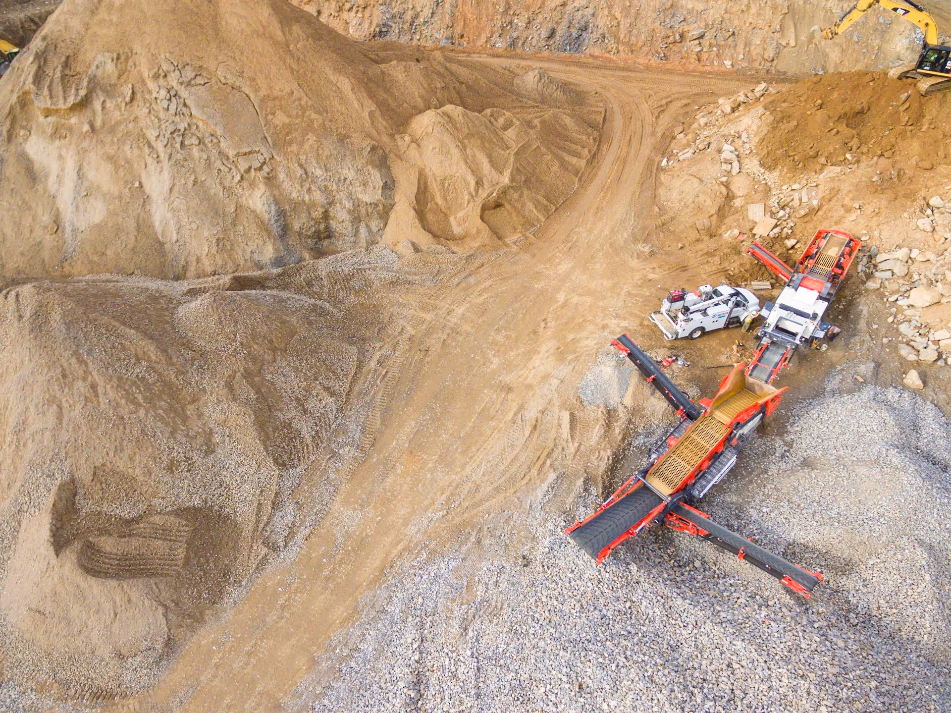 Aerial view of heavy excavation equipment on a large mining site