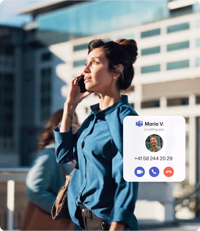 Man in suit adjusting headset microphone while looking down.
