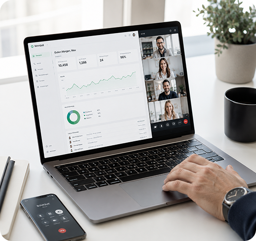 Laptop screen showing a business dashboard and video call with four participants, hand on keyboard.