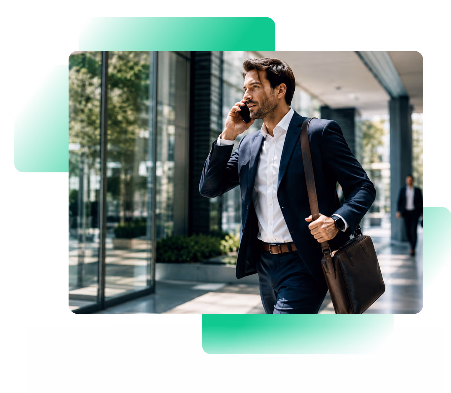 Businessman in suit walking outside a modern building while talking on his phone carrying a leather bag.
