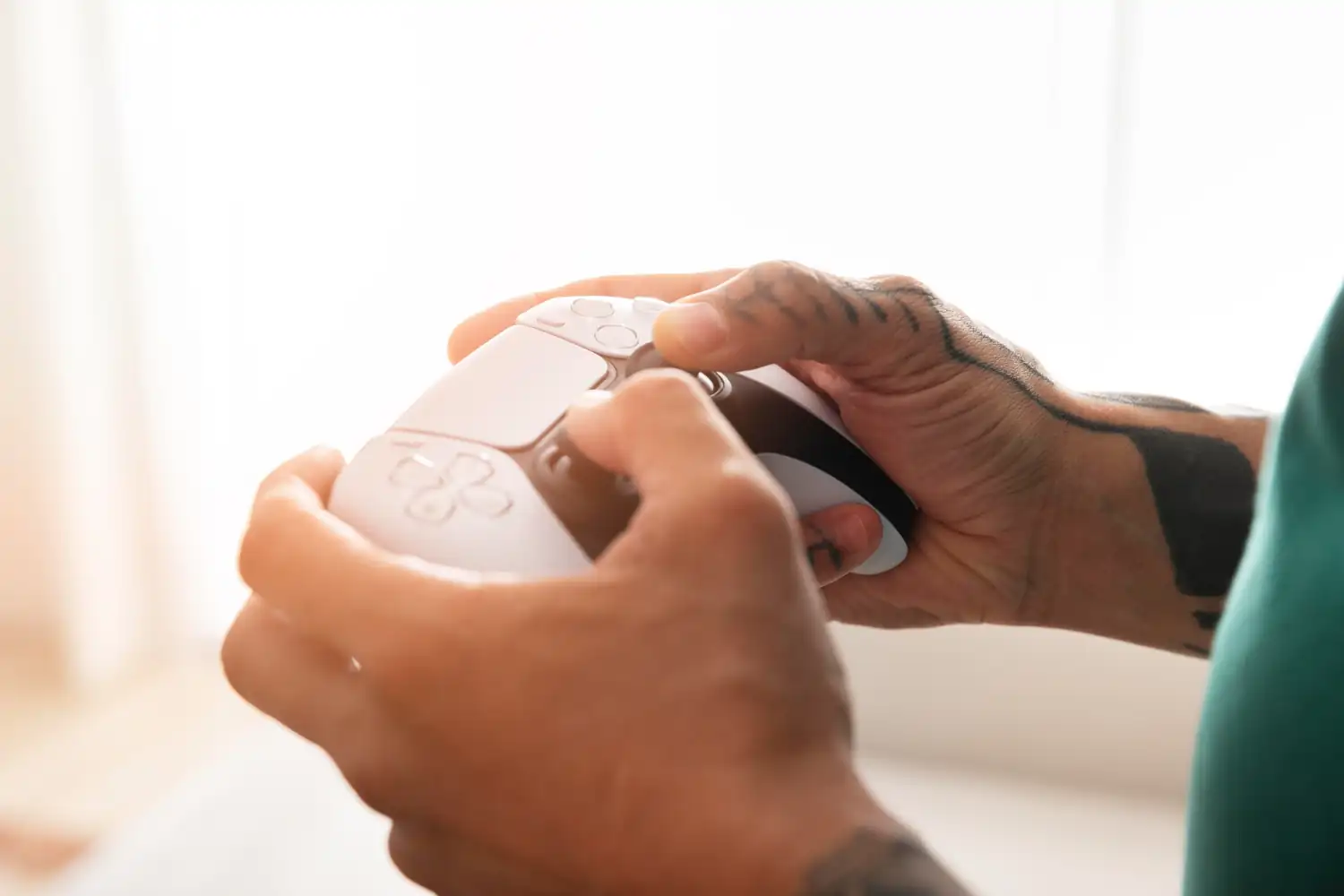 First-person perspective of hands holding a gaming controller, minimal setup, modern clean aesthetic