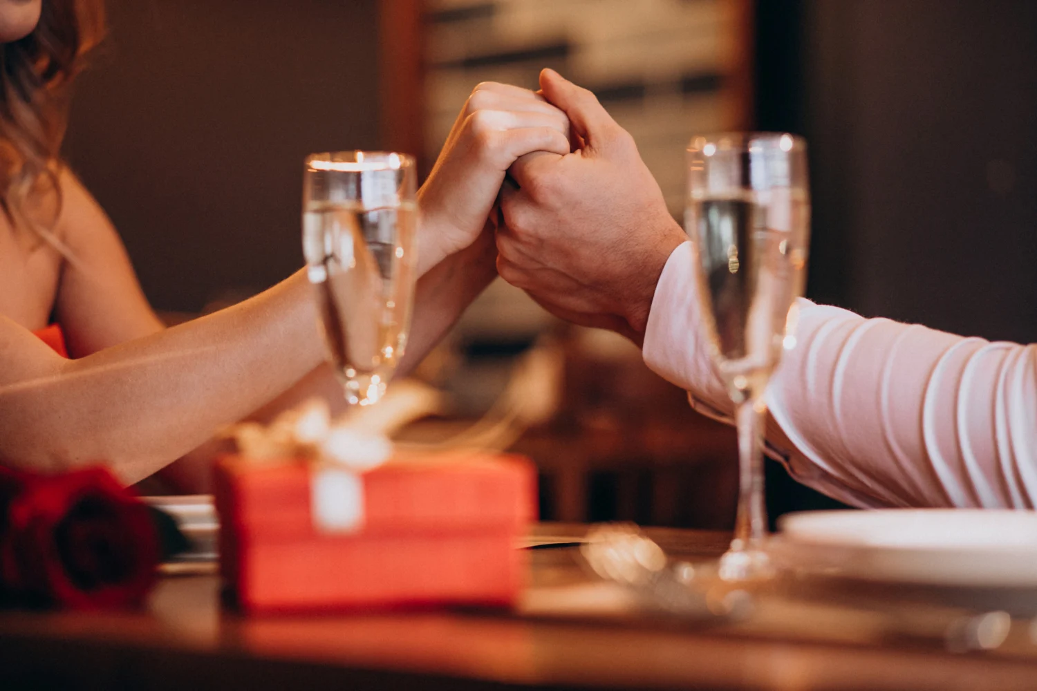 Side perspective on a couple holding hands while on a date