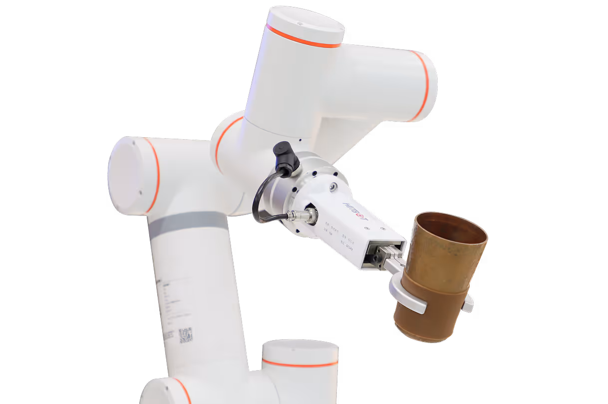 White robotic arm with orange rings holding a brown cylindrical object with a metal gripper.