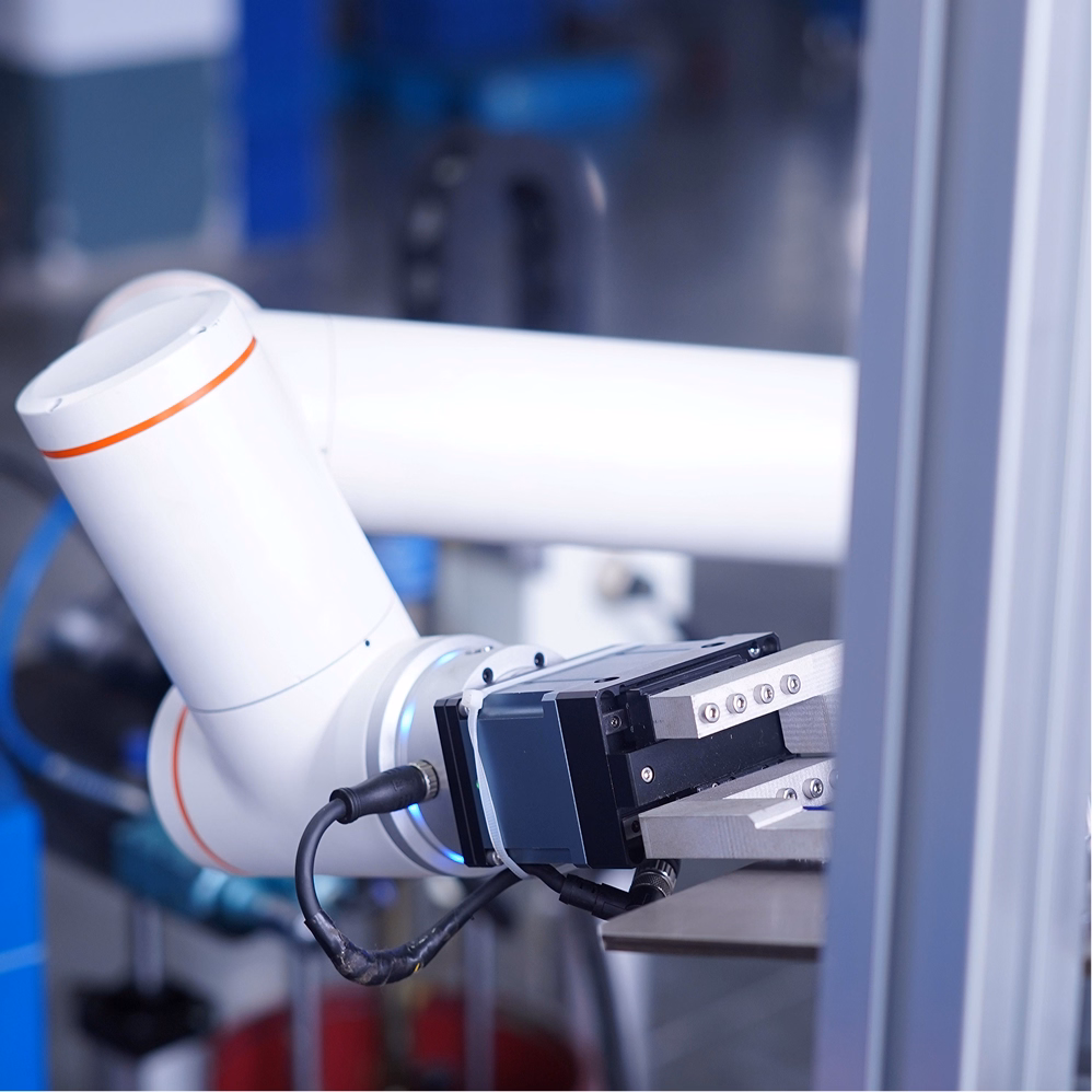 A specialized robotic system interacts with objects in a clean, high-precision environment.