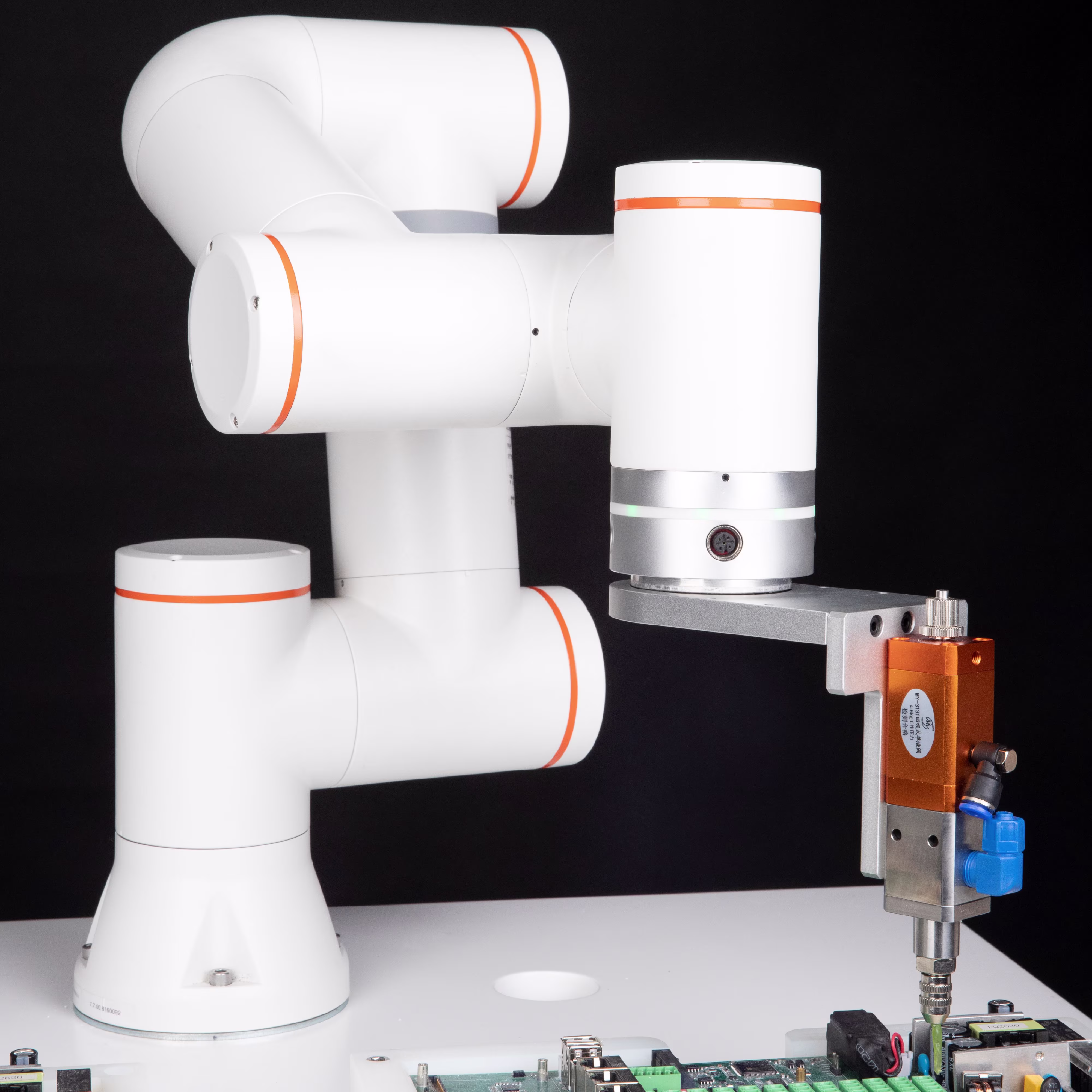 A robotic arm executes a controlled manipulation task within a high-tech laboratory or production environment.