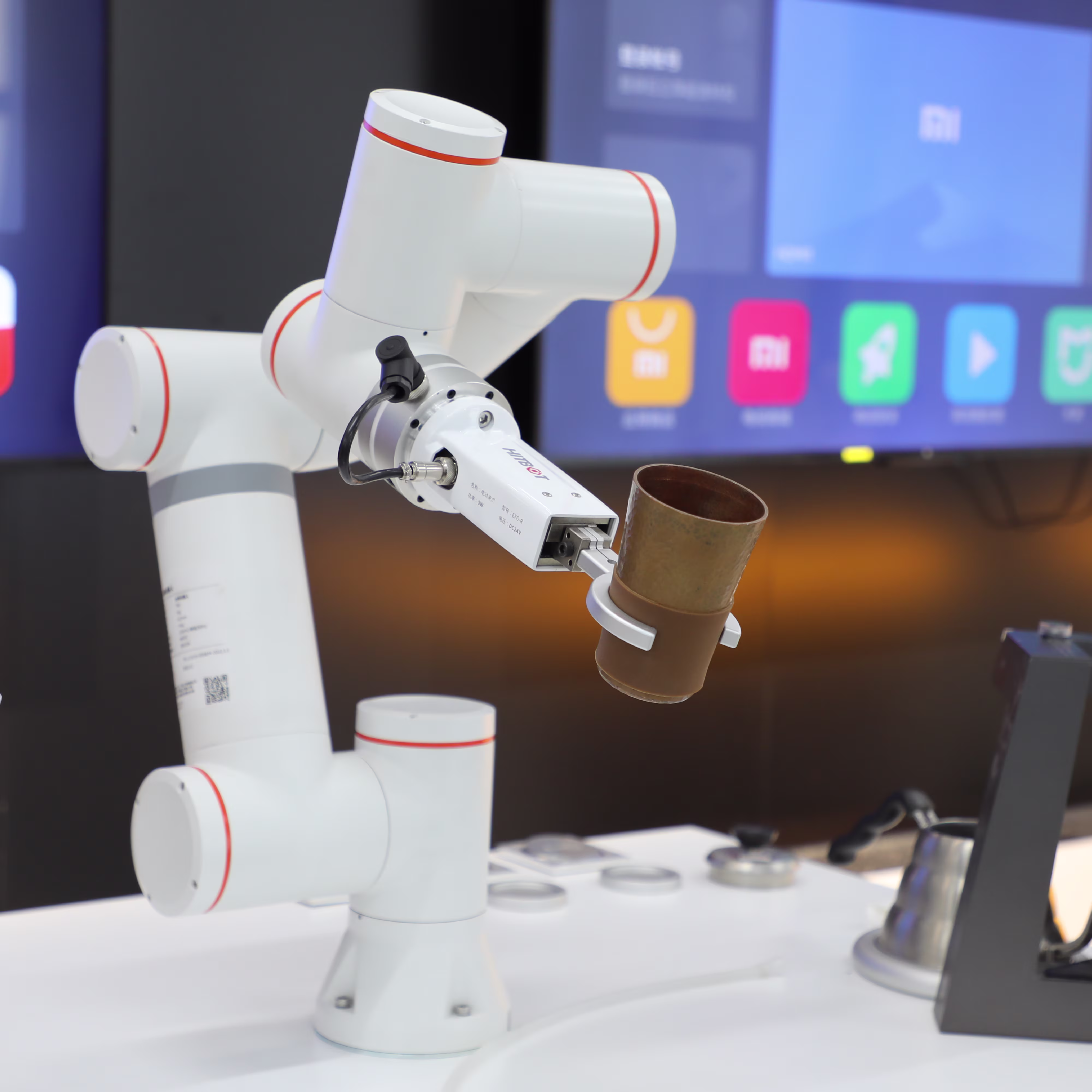 A robotic arm executes a controlled manipulation task within a high-tech laboratory or production environment.