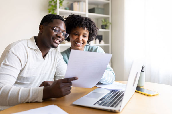 Homeowners reviewing refinance options for their existing mortgage