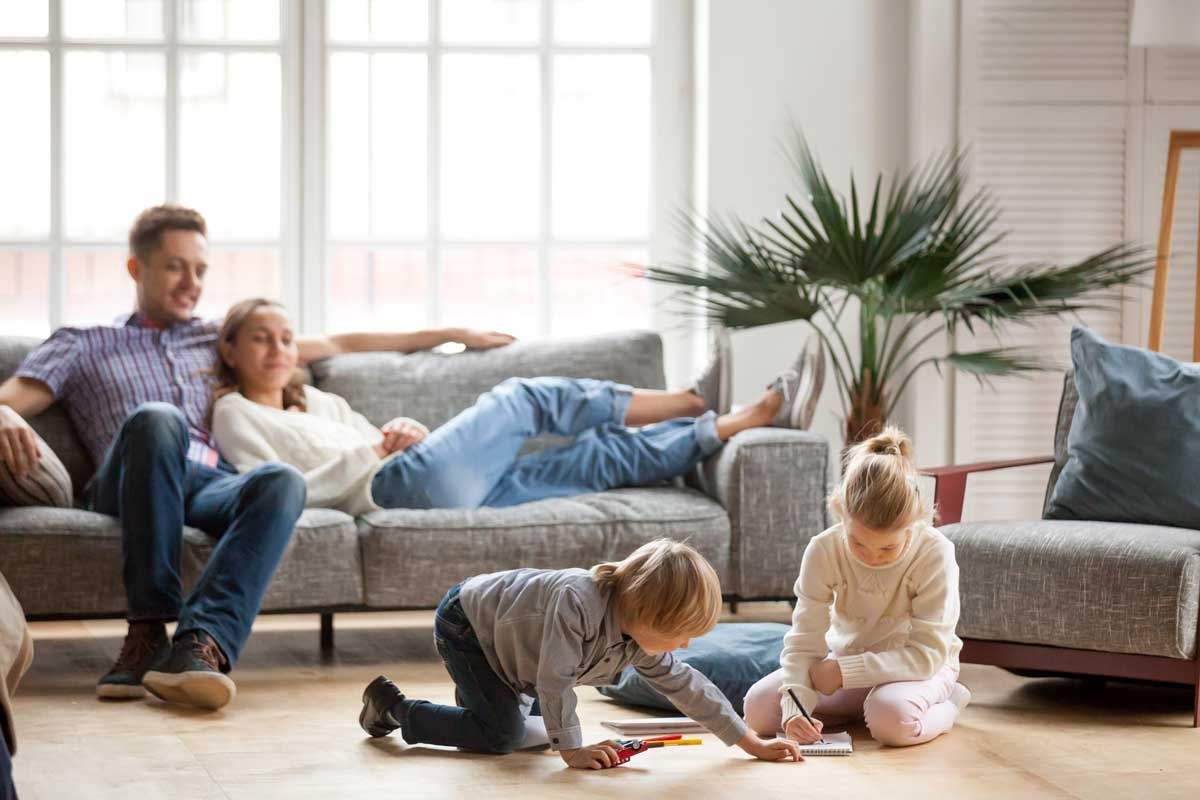 Family relaxing together in the family room of their home