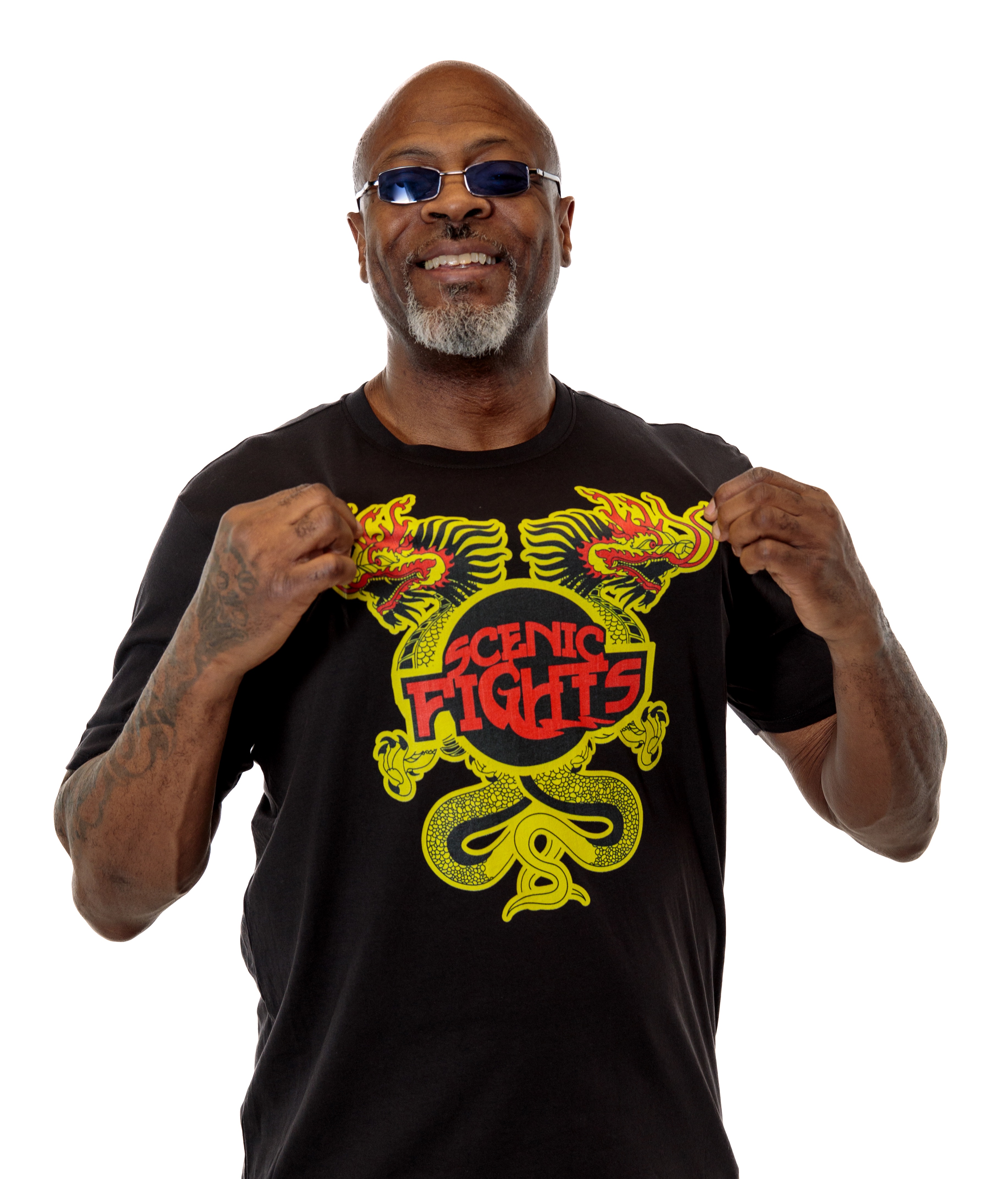 Man wearing a white hoodie with a red graphic design and text reading 'Scenic Flights' on the front.