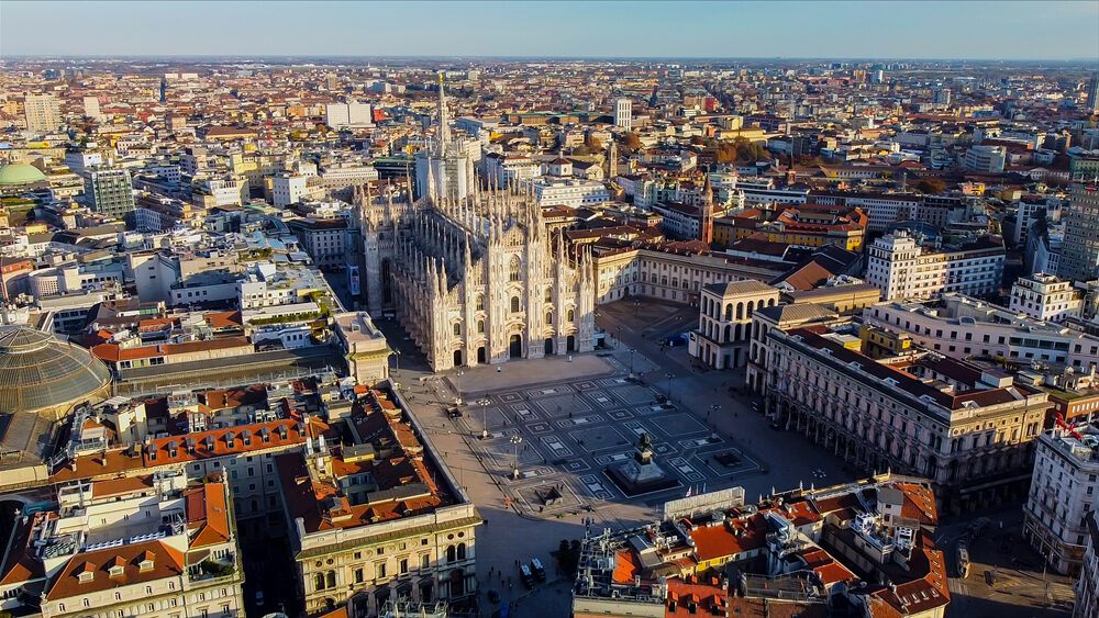 Aerial view of Milan city center featuring the Milan Cathedral and surrounding historic buildings.