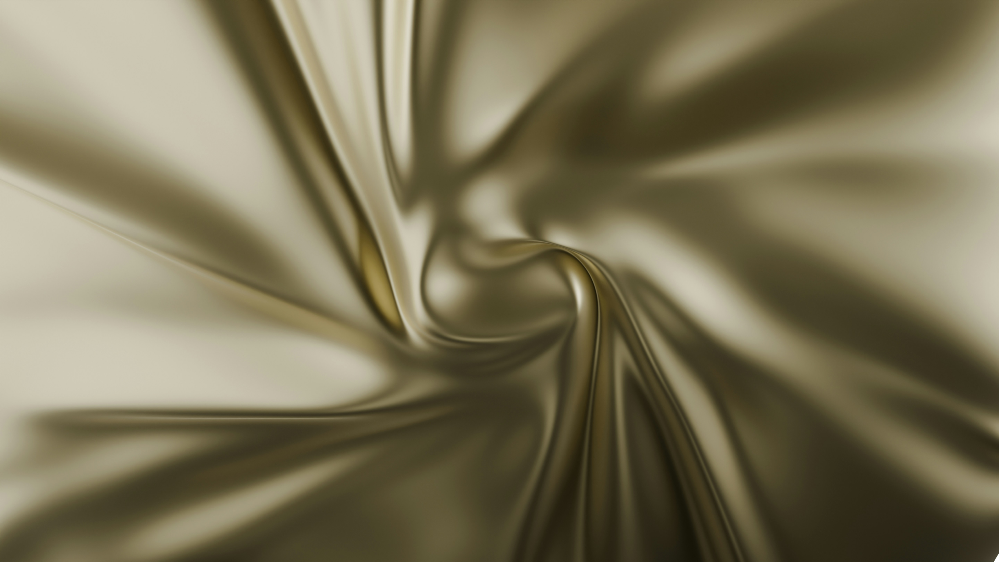 Close-up of shiny, smooth gold satin fabric with soft folds and a swirling pattern.