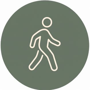Symbol einer Person, die geht, auf grünem rundem Hintergrund.
