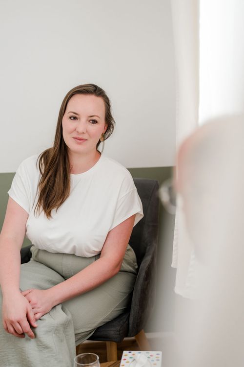 Sarah Lux und ein Kunde im Gespräch auf einem Tisch mit Gläsern und Wasser.