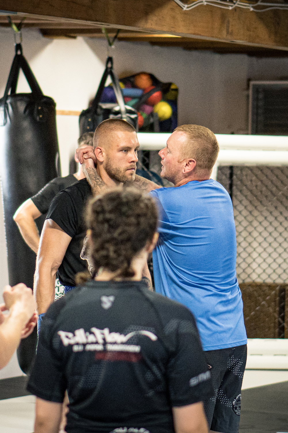 Coach Micha demonstriert Techniken aus dem Clinch beim Training im Thaiboxen, andere Teilnehmer beobachten.