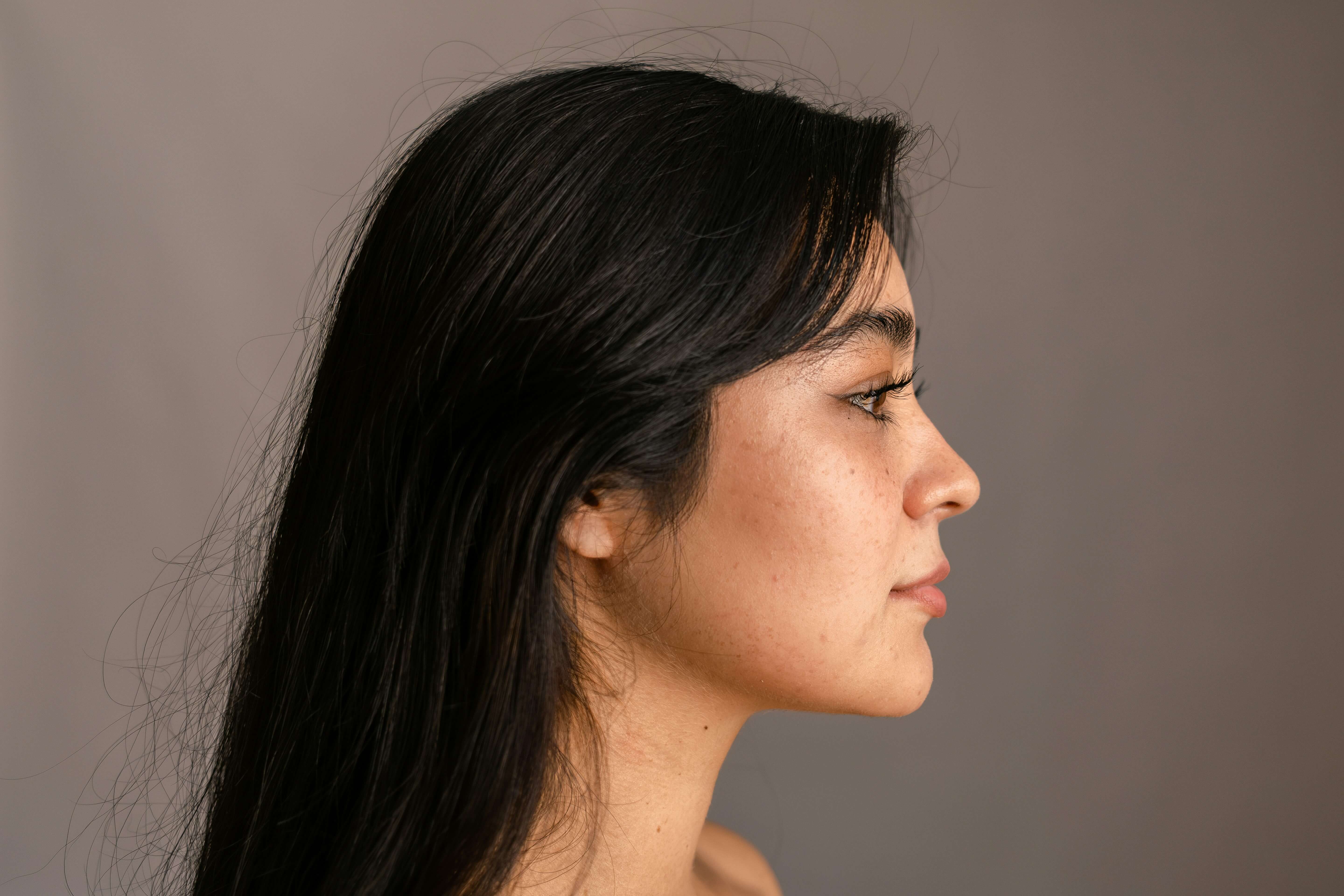 Close-up of mature lips showing fine vertical lip lines that naturally develop with age and collagen loss.