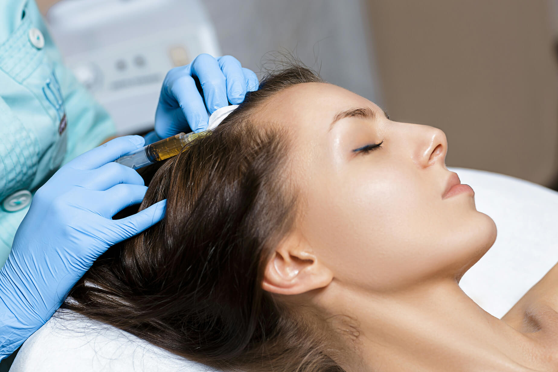 Professional applying scalp injection treatment to support hair growth and improve scalp health.
