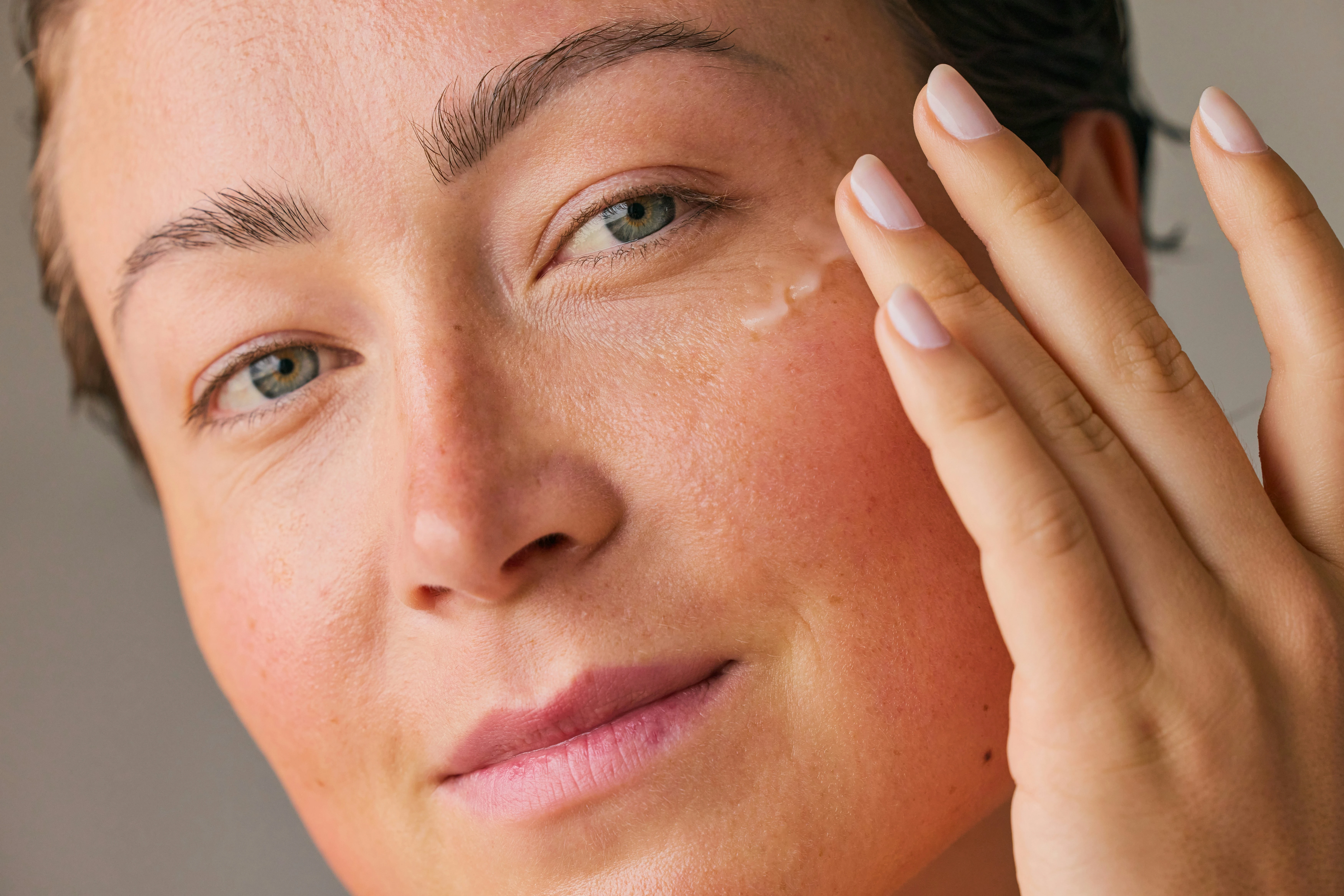 Woman applying skincare after Botox treatment to support healthy skin and maintain smoother, youthful-looking results