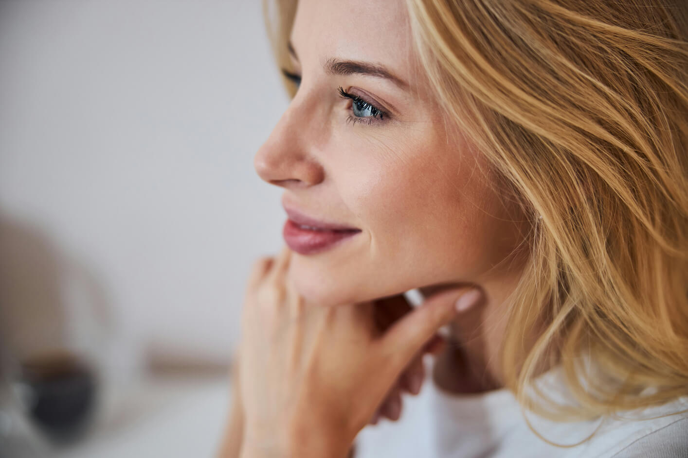 Woman in her 40s with healthy skin representing corrective aesthetic treatments for fine lines, collagen loss, and skin rejuvenation