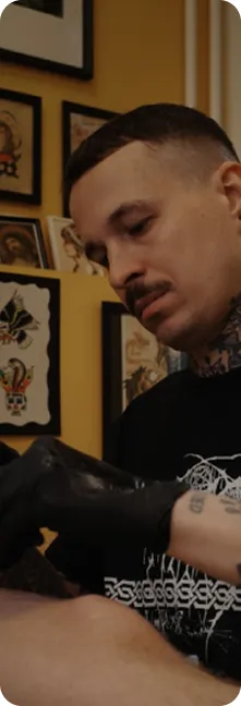 Sergei, tattoo artist at A Better Way Tattoo Parlour, tattooing a client's wrist in the Berlin studio