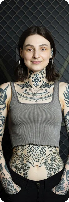 Aggie, tattoo artist at A Better Way Tattoo Parlour, portrait showing her tattoo work, Berlin