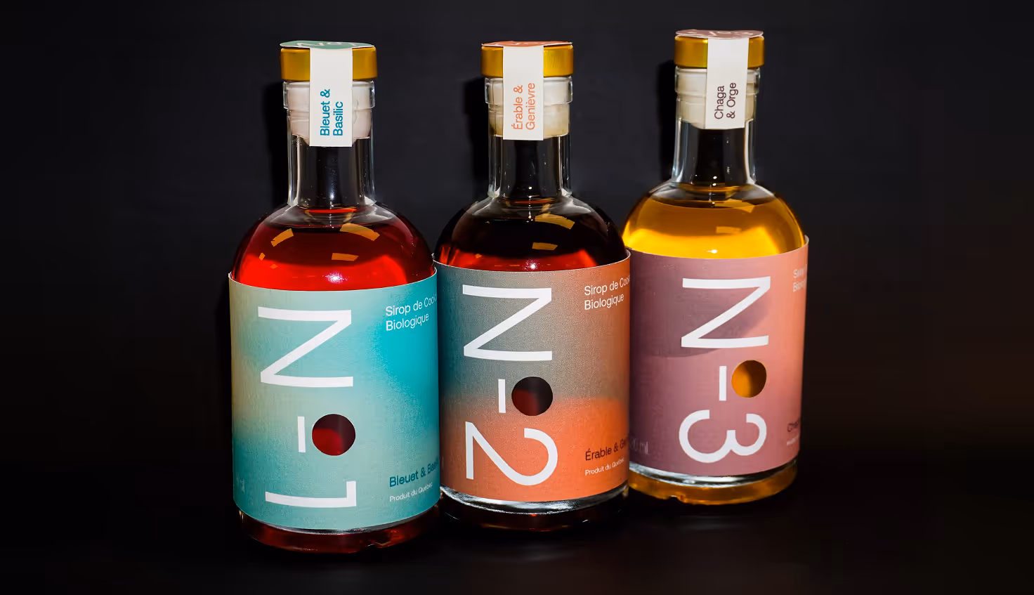 Photographed by Xhalia Martineau - Three numbered bottles of organic syrup labeled N-1, N-2, and N-3 with different flavors.