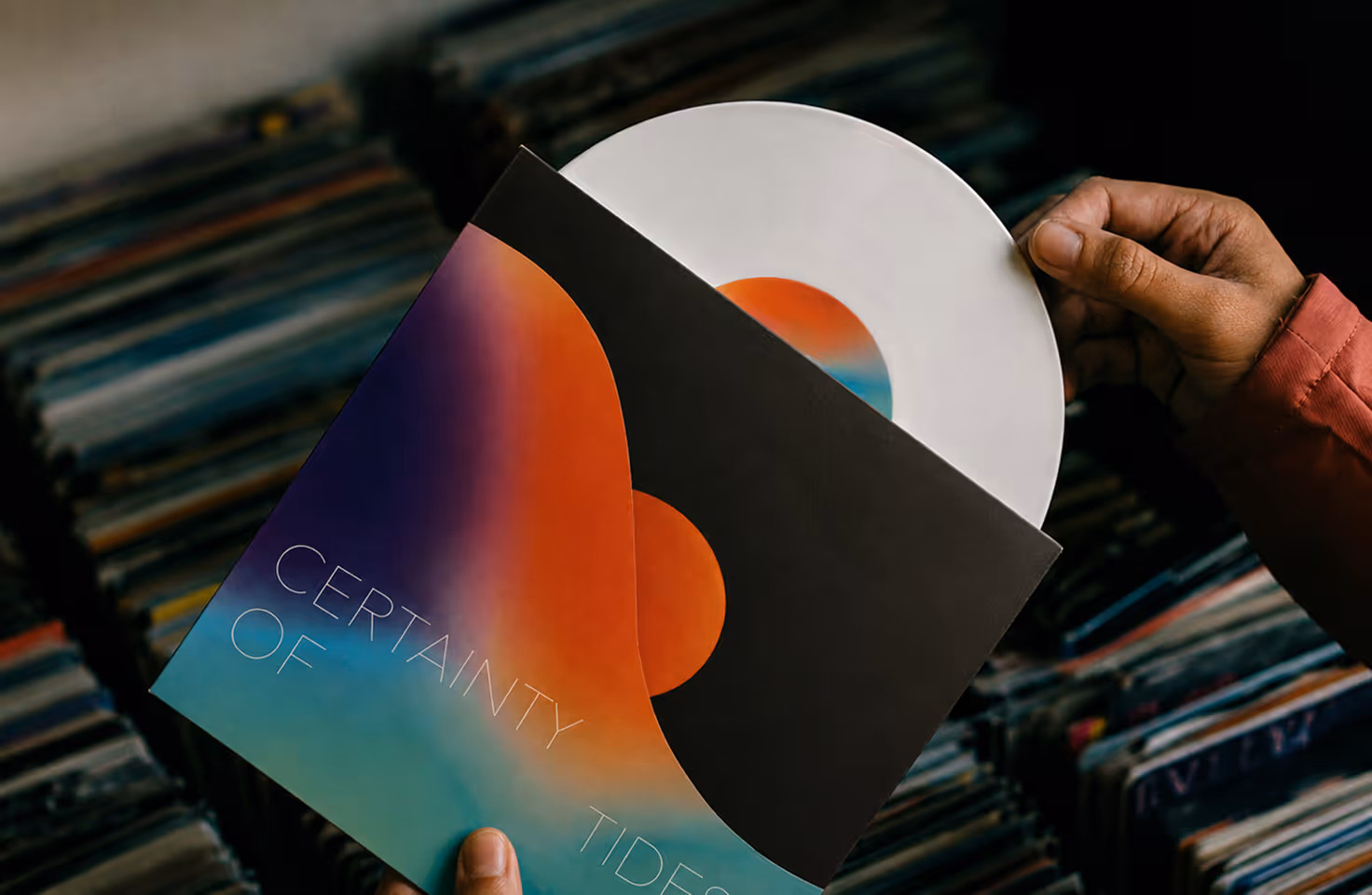AI Generated image by ChatGpt - Hands holding a vinyl record and a colorful album cover with 'Certainty of Tides' text.