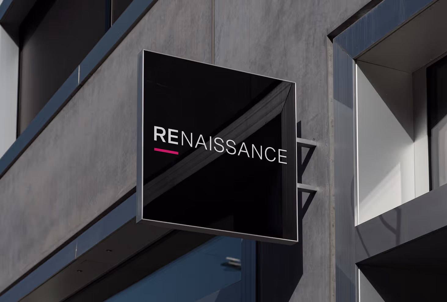 Mockup from Maison Mockup - Black square sign on building wall with word 'RENAISSANCE' in white and pink underline under RE.