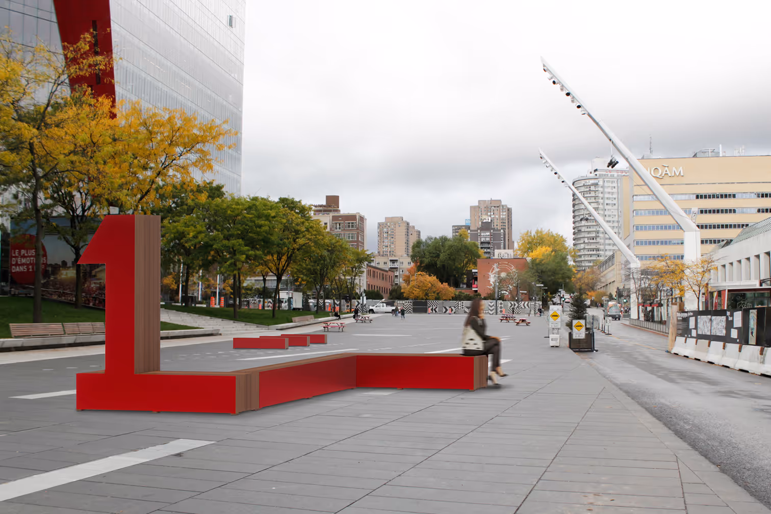 Urban plaza with red number 1 bench, trees with autumn leaves, and city buildings in the background.