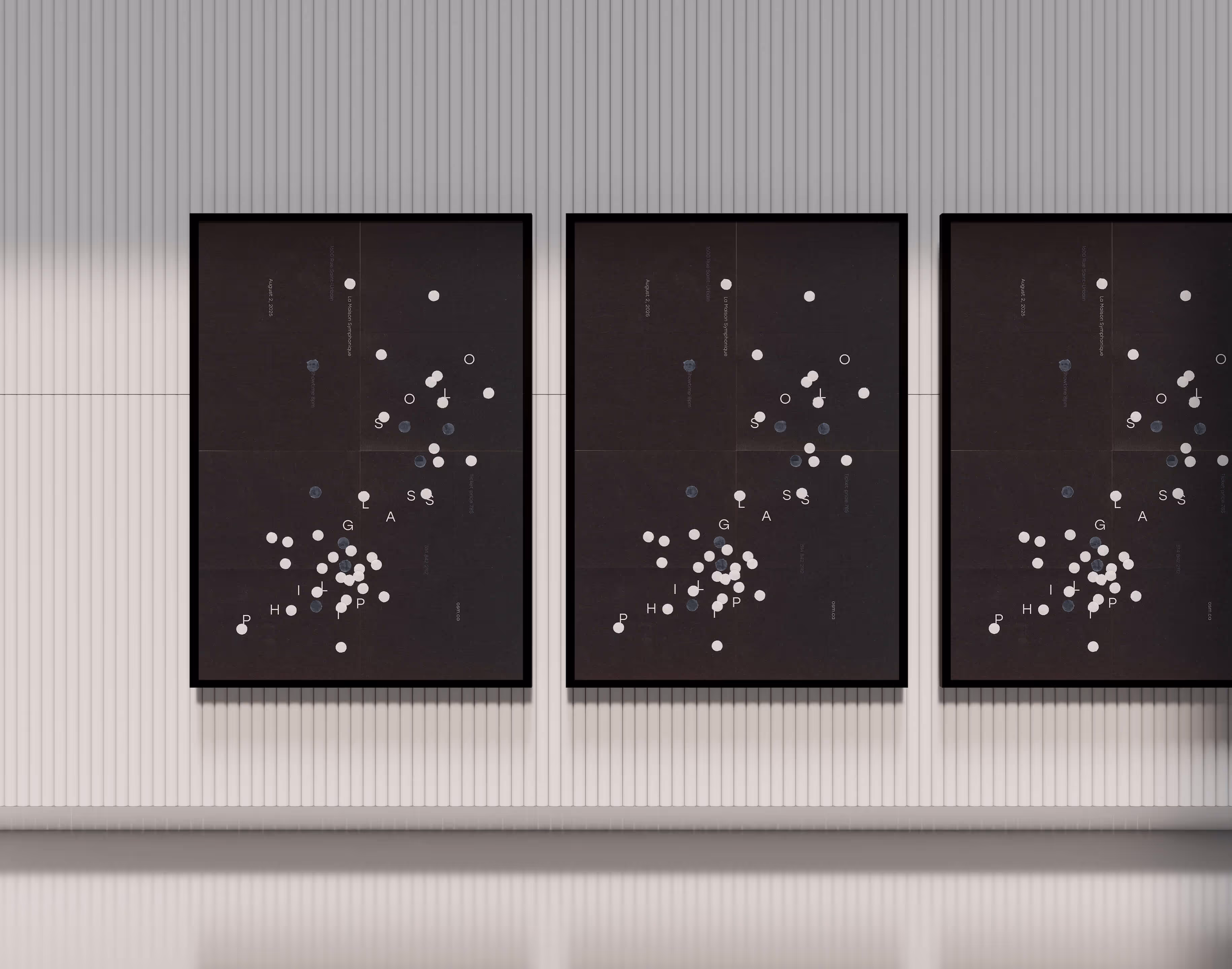 Three black framed posters with white and gray dots arranged randomly on a ribbed white wall.