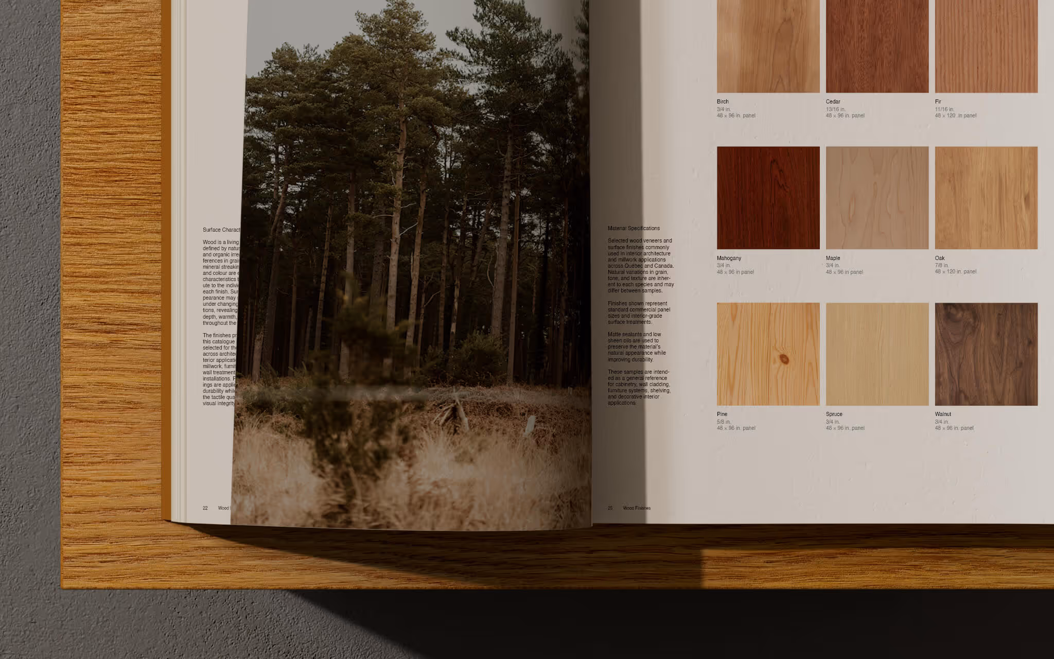 Open book showing a forest photo and wood sample swatches with descriptions on a wooden table.