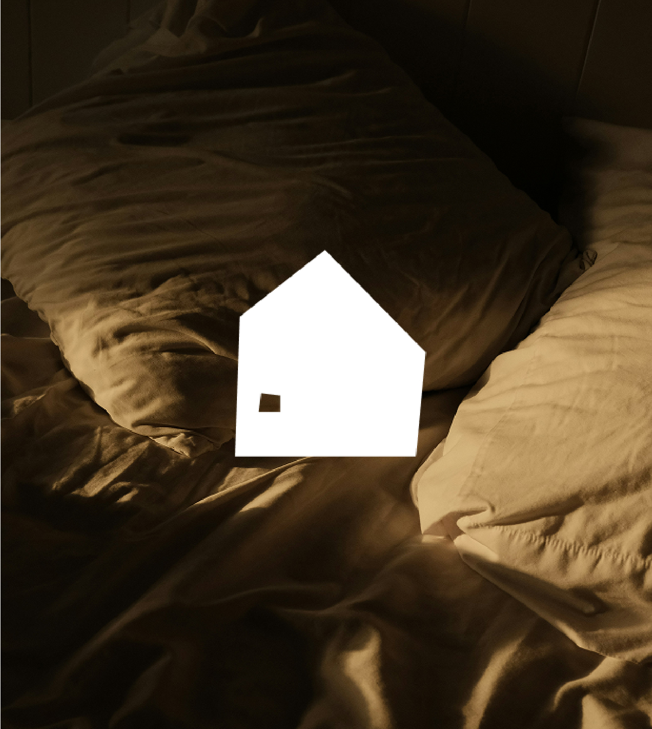 White house icon projected onto rumpled brown bed sheets with soft lighting.