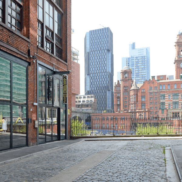 A photo of the entrance to 86 Princess Street, with views of Manchester skyline in the distance