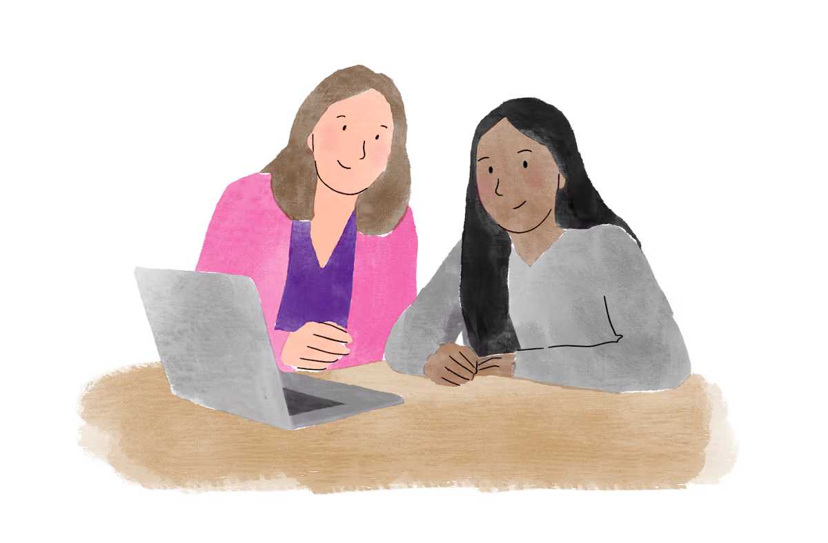 A teacher and a pupil looking at a laptop together