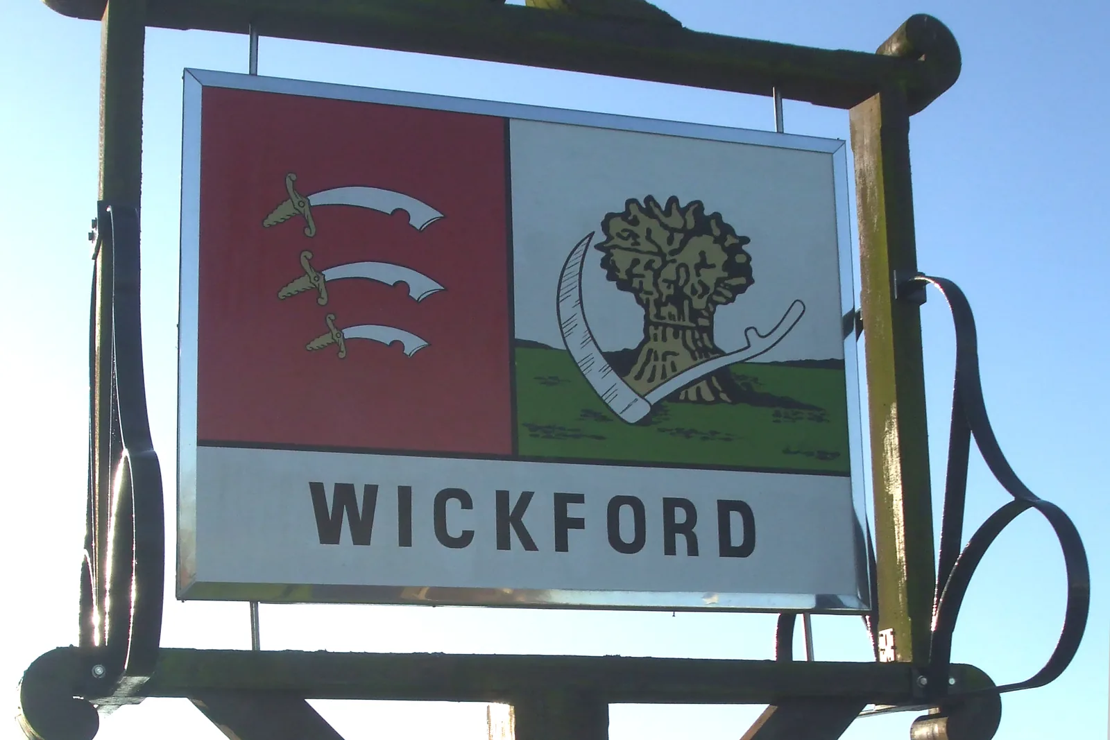 Wickford town sign showing the Essex three seaxes, a wheatsheaf and a scythe