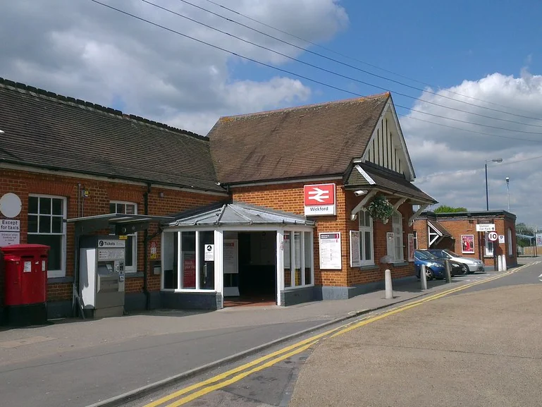 Wickford railway station entrance with its red brick building and ticket office