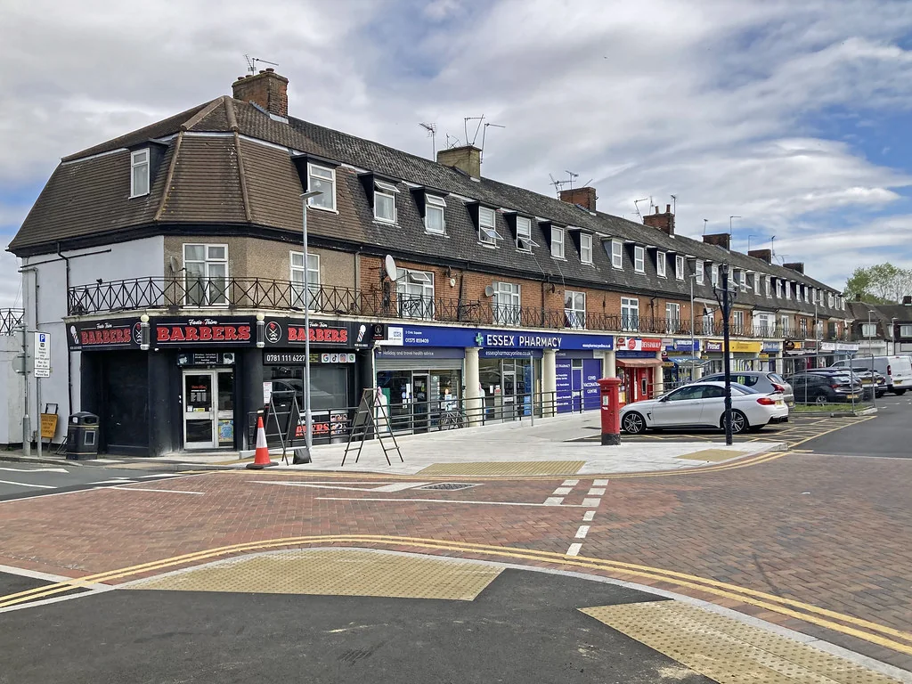 Parade of local shops with flats above on a corner in Tilbury
