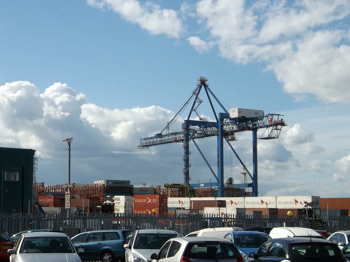 Blue container crane and stacked shipping containers at the Port of Tilbury