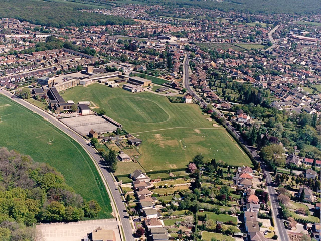 Aerial view of Thundersley homes and school playing fields with woodland in the foreground