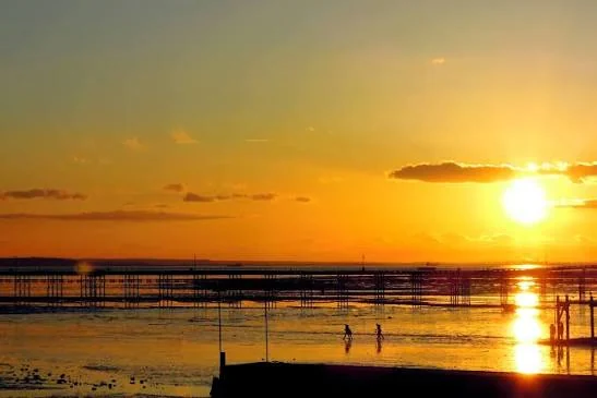 Sunset over the Thames Estuary with Southend Pier stretching out across the mudflats