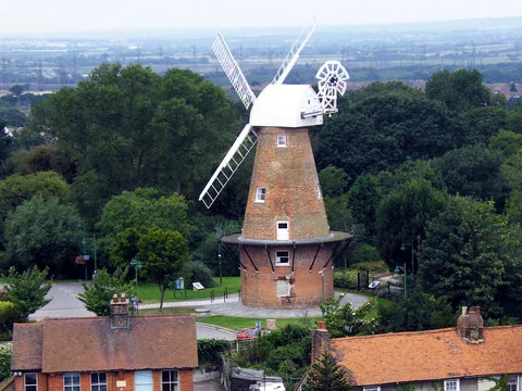 Rayleigh Windmill among trees above the rooftops of the town