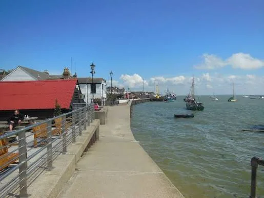 Waterfront path in Old Leigh with moored boats on the estuary