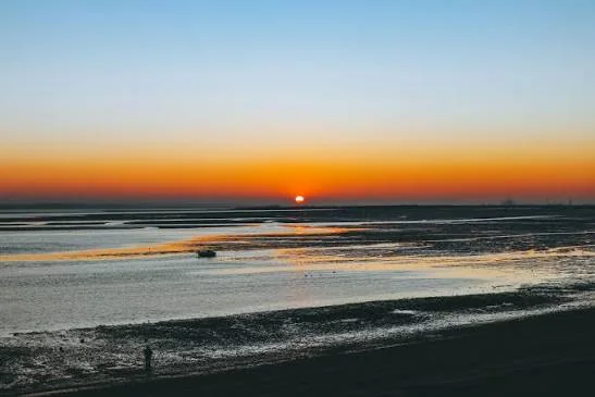 Sun setting over the mudflats of the Thames Estuary at Leigh-on-Sea