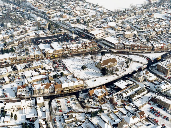 Snow-covered aerial view of Hadleigh town centre and the church on the A13
