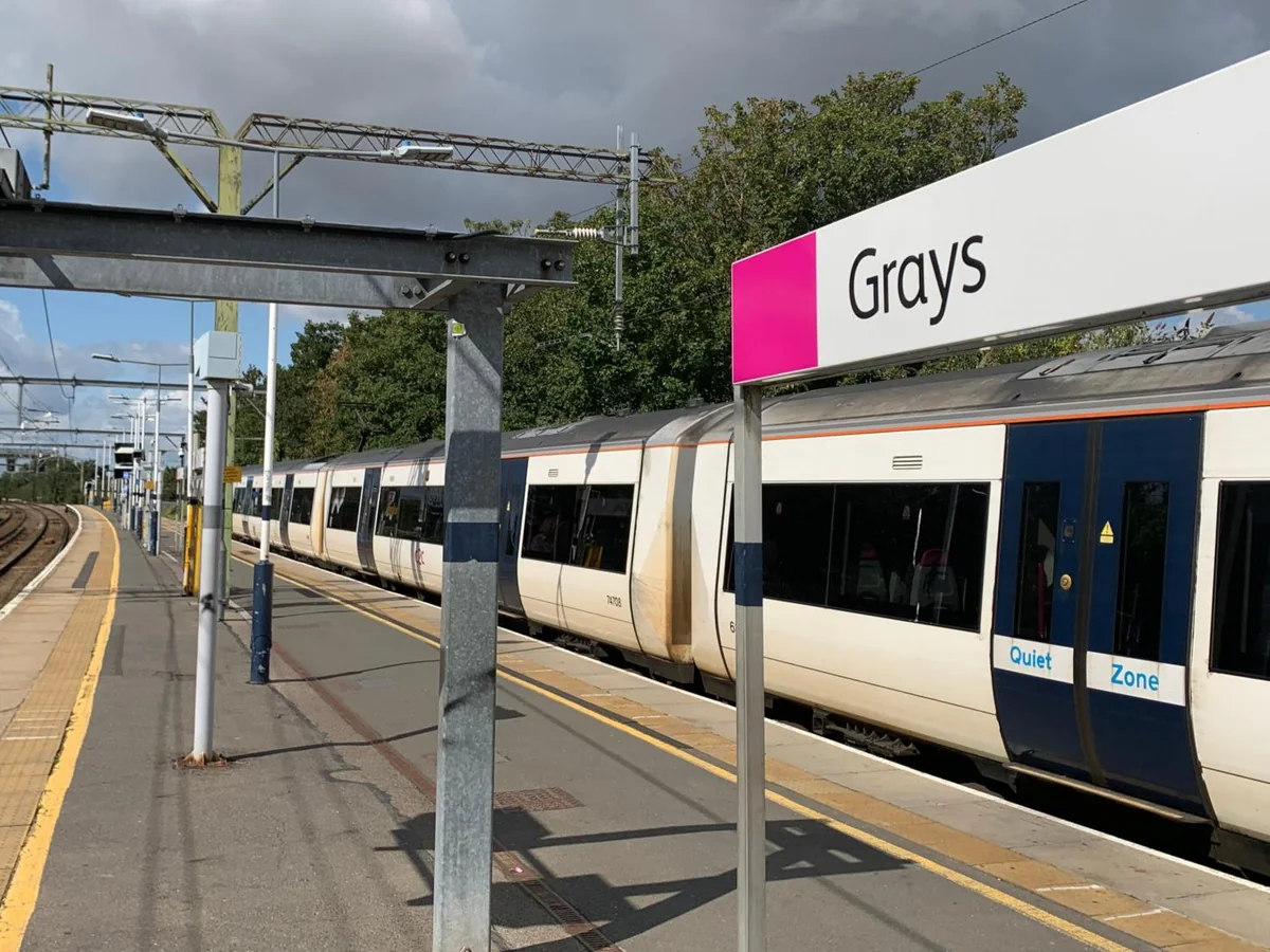 c2c train at the platform beside the Grays station sign