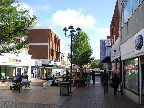 Shops and market stalls in the pedestrianised High Street in Grays town centre