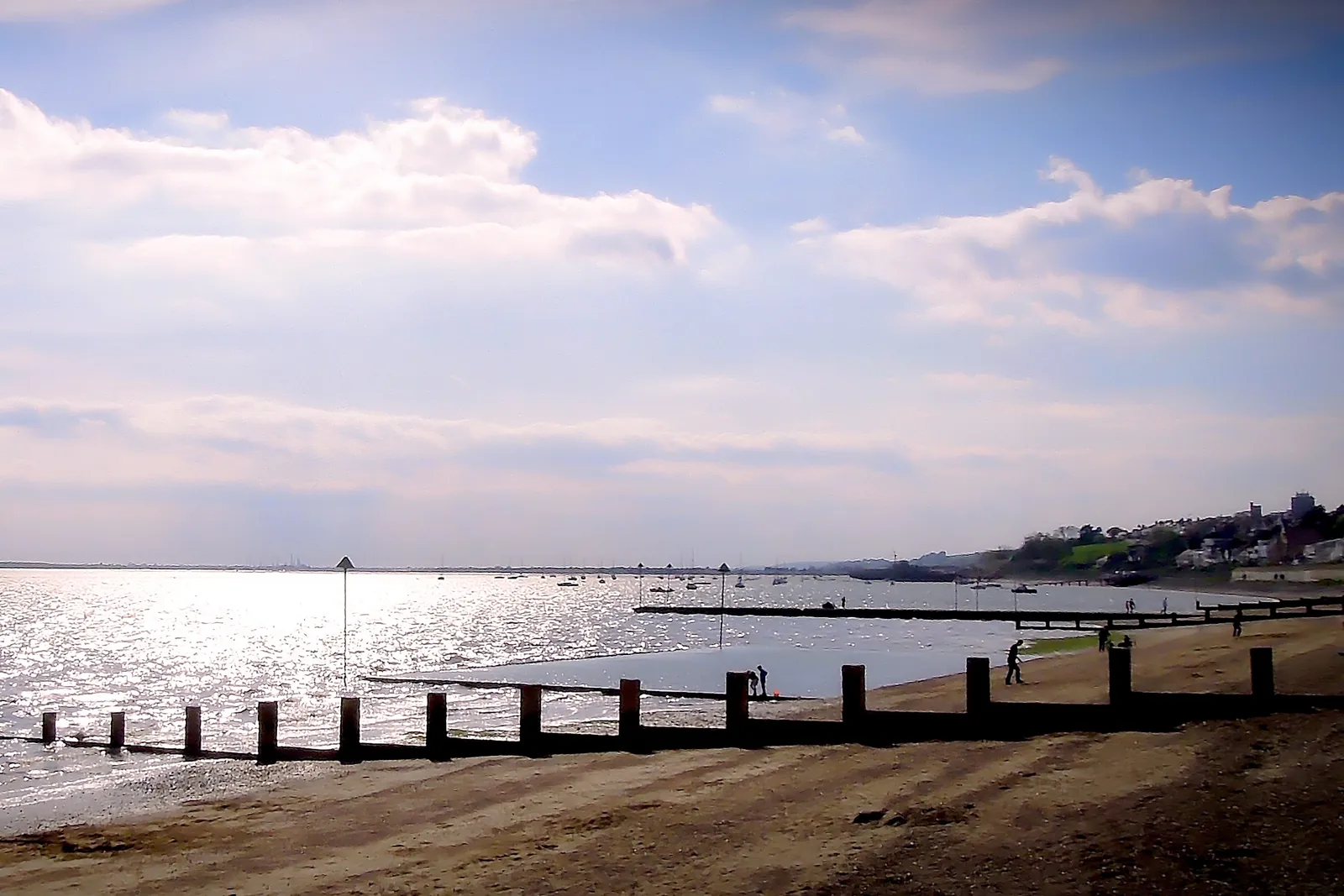 Chalkwell beach with wooden groynes running into the sparkling Thames Estuary