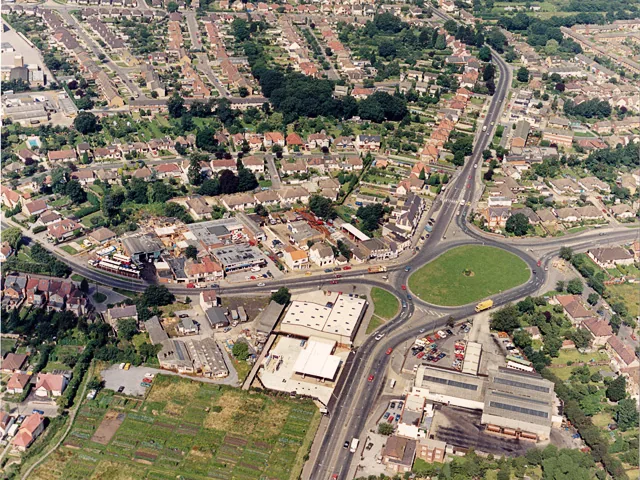Aerial view of homes, shops and a large roundabout in Castle Point