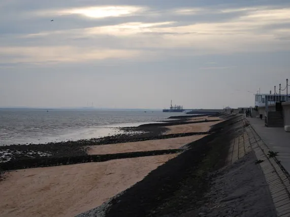 Canvey Island sea wall and promenade above the beach and groynes