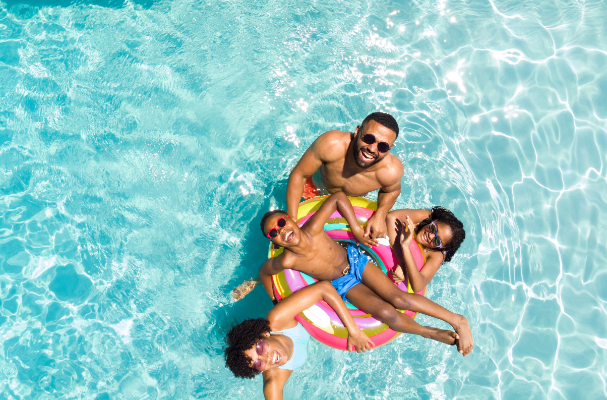 Family in swimming pool stock image